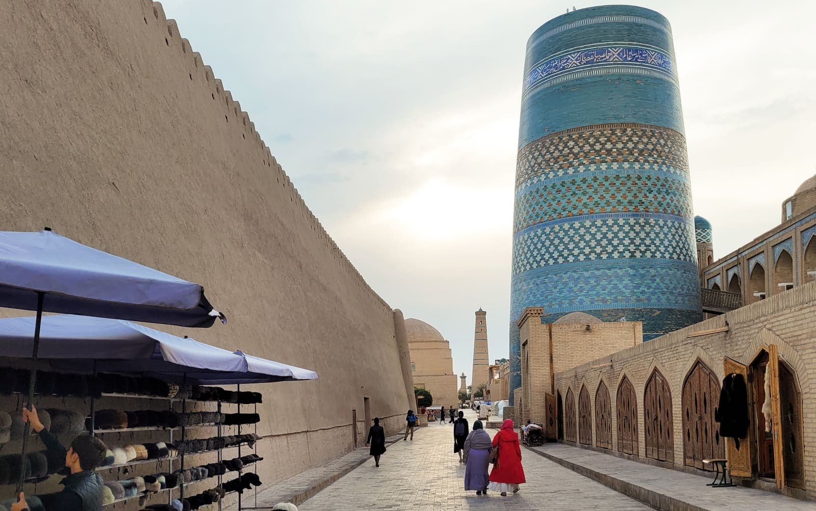 The blue-tiled Kalta Minor minaret on a street inside Khiva's old town